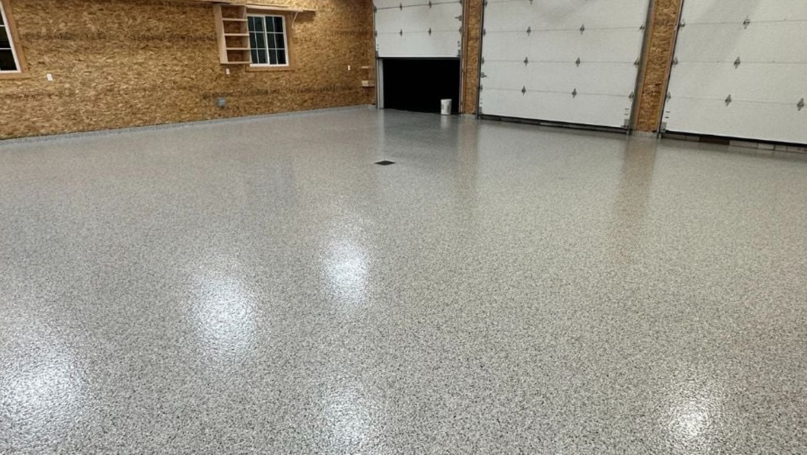 The same pole-barn garage after a showroom-grade flake floor coating