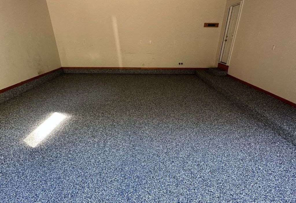 Spare room finished with a durable blue flake floor coating